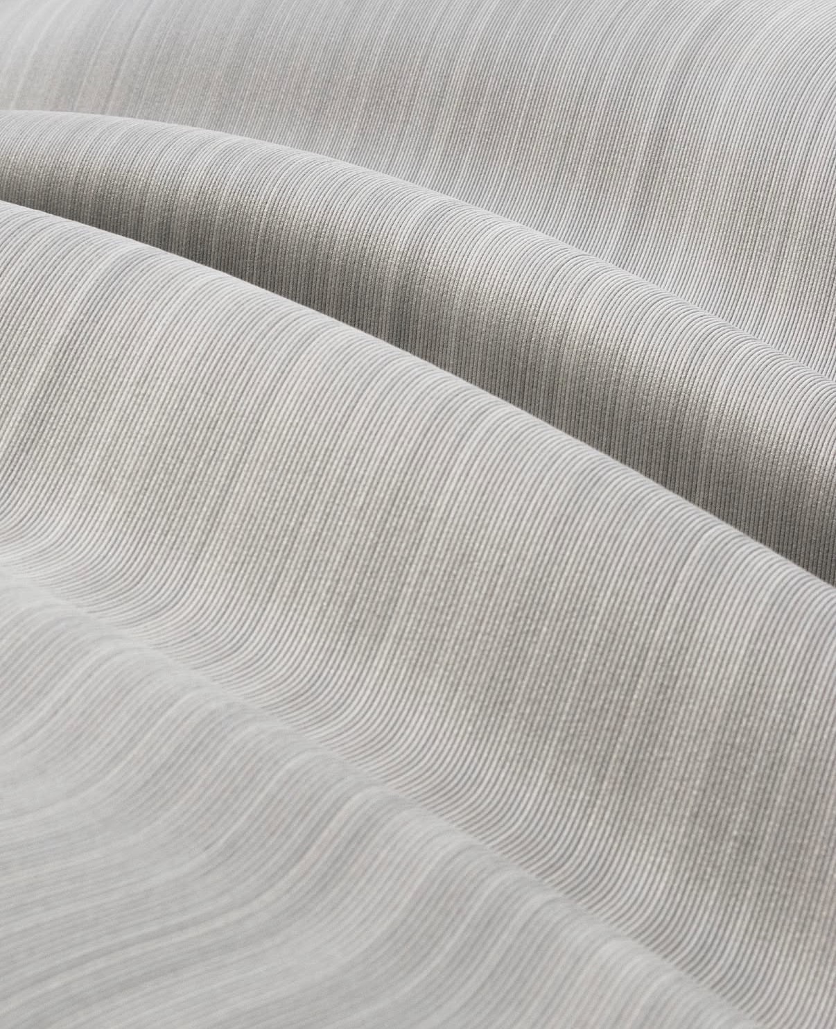 Close-up of recycled polymer 3D-printed surface showing layered wave texture