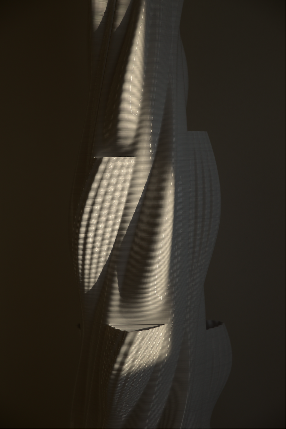 Large-format 3D printed column in progress, showing layered additive manufacturing texture